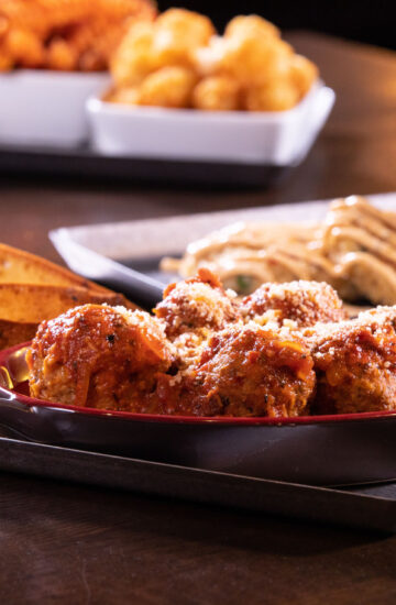 Bacon Meatballs - One of our best sellers: Pork, beef and bacon meatballs, spicy amatriciana sauce, garlic toast points House Specialty