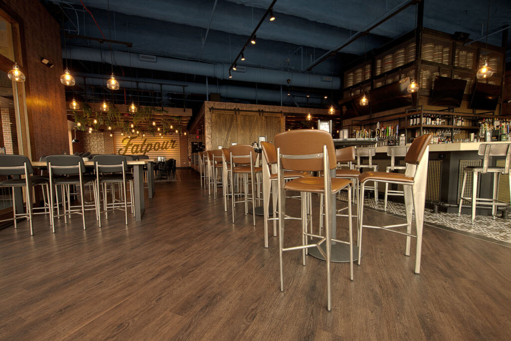 Main bar space with TVs and multiple seating arrangements at Fatpour Lincolnwood