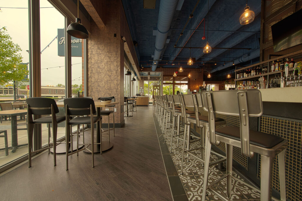 Main bar space with TVs and multiple seating arrangements at Fatpour Lincolnwood