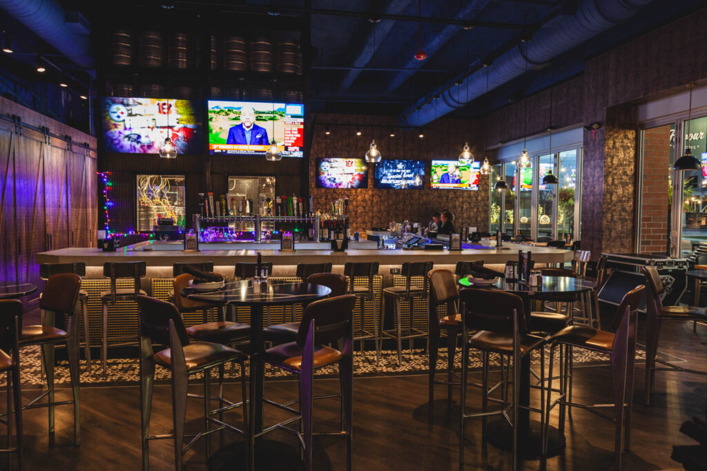 Main bar space with TVs and multiple seating arrangements at Fatpour Lincolnwood