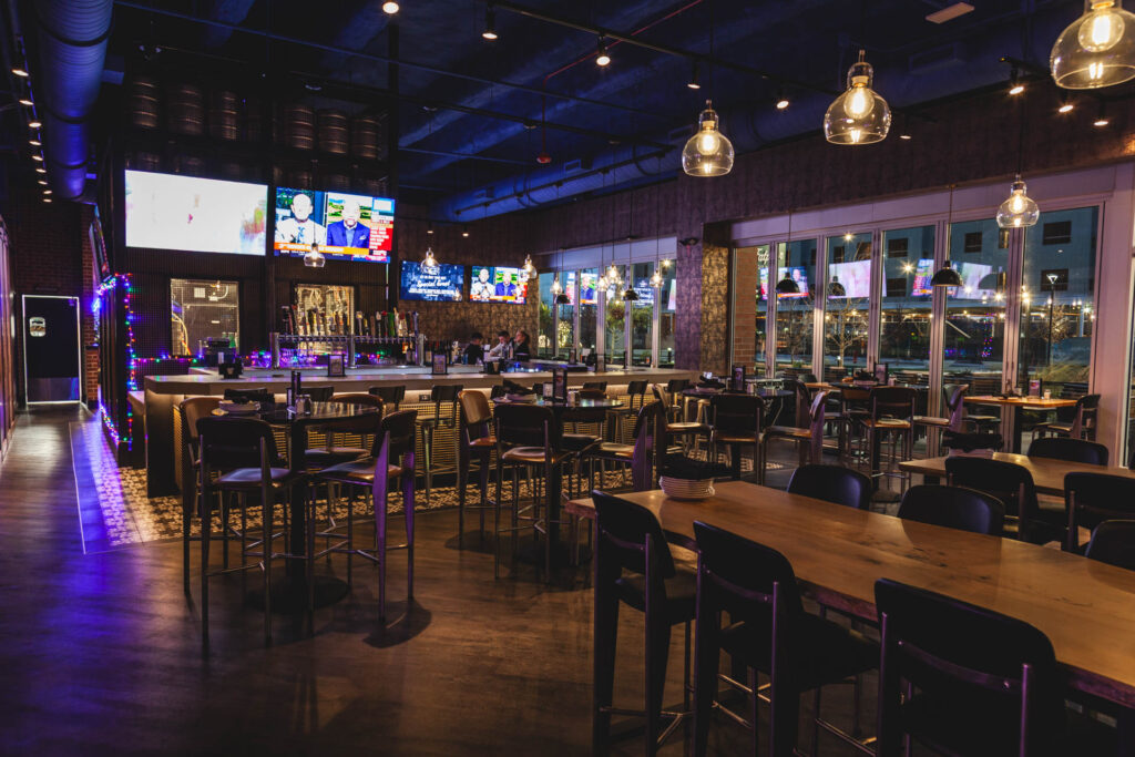 Main bar space with TVs and multiple seating arrangements at Fatpour Lincolnwood