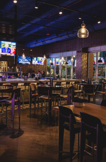 Main bar space with TVs and multiple seating arrangements at Fatpour Lincolnwood