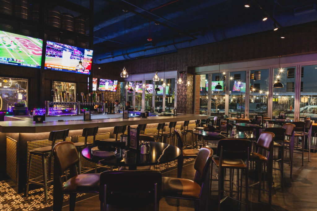Main bar space with TVs and multiple seating arrangements at Fatpour Lincolnwood