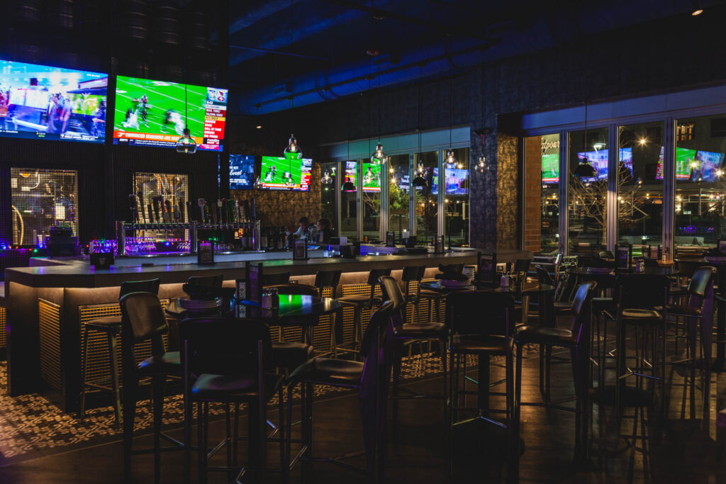 Main bar space with TVs and multiple seating arrangements at Fatpour Lincolnwood