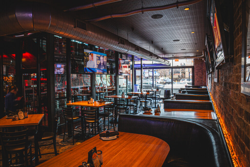 Booths and main dining room with TVs