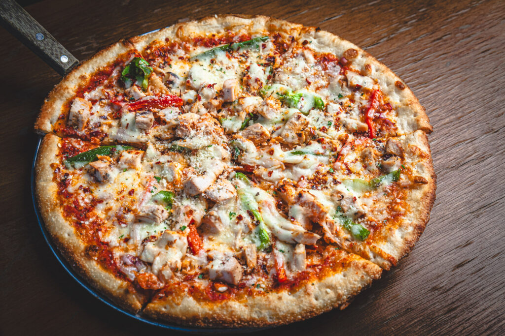 Cluckin Pizza Special at Fatpour Wicker Park: red sauce, diced grilled chicken, red and green bell peppers, red onion, red pepper flake