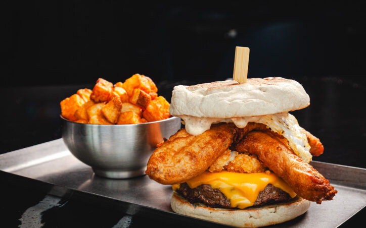 FP’S BA BREAKFAST BURGER | $17.75 WAFFLE BATTERED BACON, OVER EASY EGG, SMASHED TATER TOTS, MAPLE SRIRACHA MAYO, EXTRA AMERICAN CHEESE, TOASTED ENGLISH MUFFIN BUN. SERVED WITH GOLDEN BRUNCH POTATOES