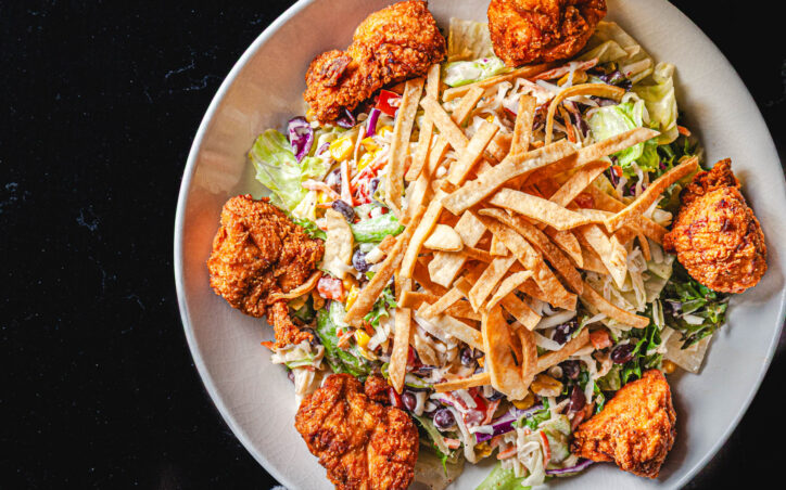 The Southern Salad - Southern fried chicken, tomato, roasted corn, black beans, tortilla strips and pepper jack cheese tossed in creamy chipotle ranch