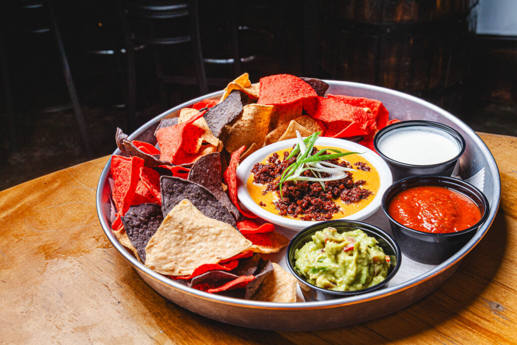 World Cup Food Special - Pitch Please Dip: Tricolored tortilla chips, chorizo, beer queso, sour cream, guacamole and fire roasted tomato salsa for just .95