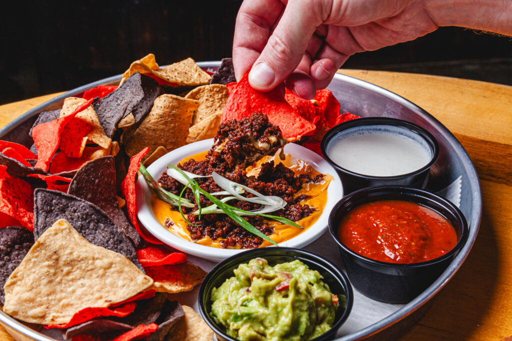 World Cup Food Special - Pitch Please Dip: Tricolored tortilla chips, chorizo, beer queso, sour cream, guacamole and fire roasted tomato salsa for just .95