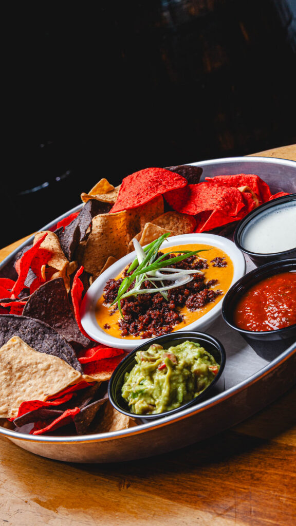 World Cup Food Special - Pitch Please Dip: Tricolored tortilla chips, chorizo, beer queso, sour cream, guacamole and fire roasted tomato salsa for just .95